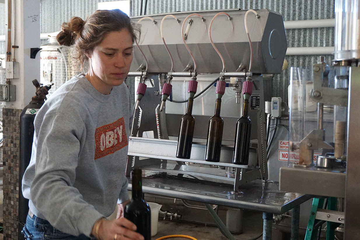 Sofia moving wine from filler to corker.